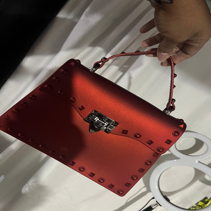 Red studded jelly crossbody purse, side view